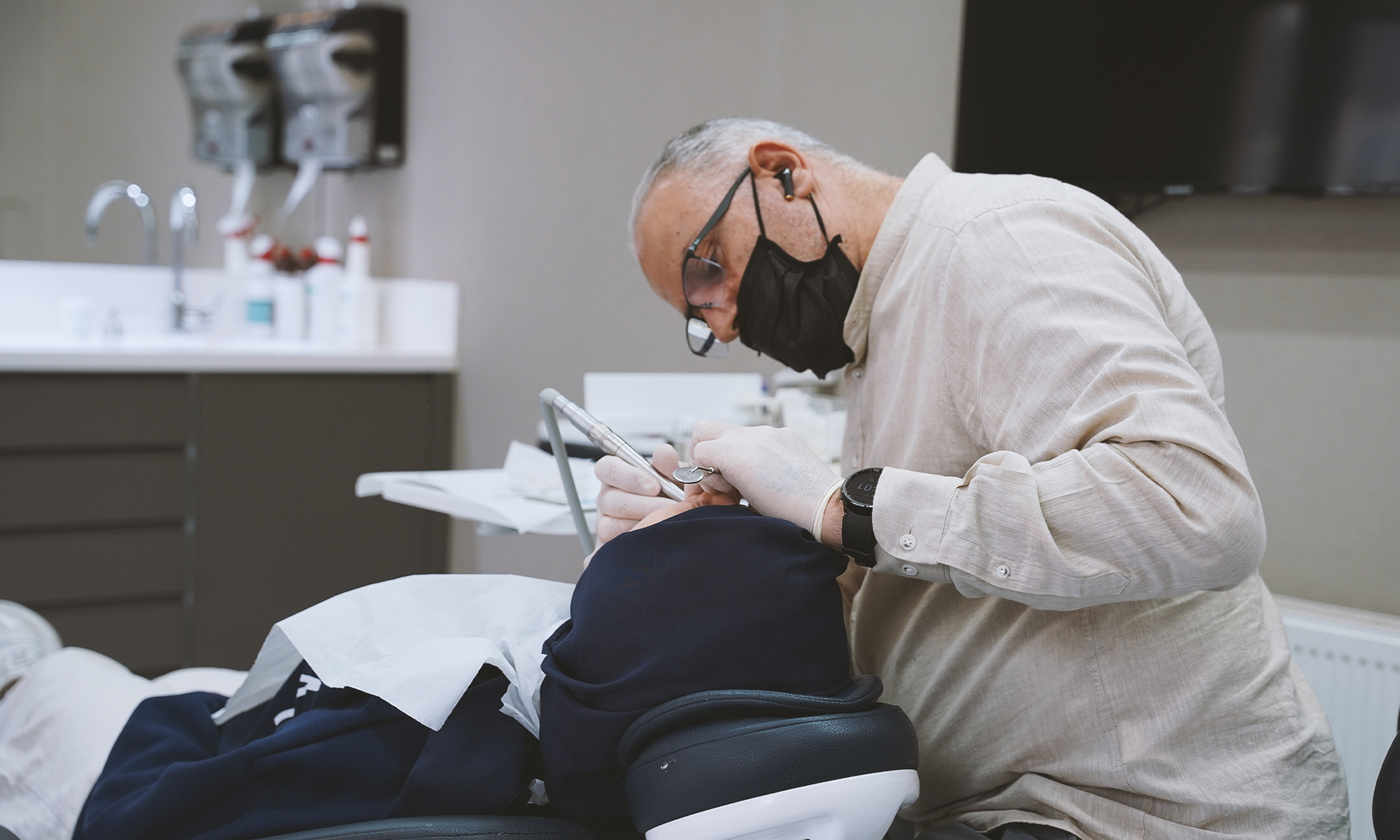 Adil Dent doctor examining patient with advanced dental equipment